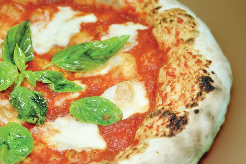 Fresh dion's pizza coming out of the oven